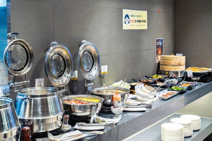 A variety of breakfast items are available at the buffet.