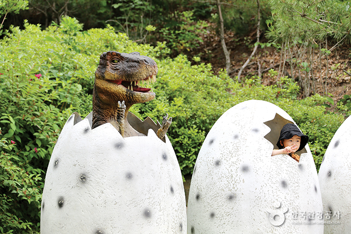 공룡알 모형 안에서 브이자를 해보는 어린이