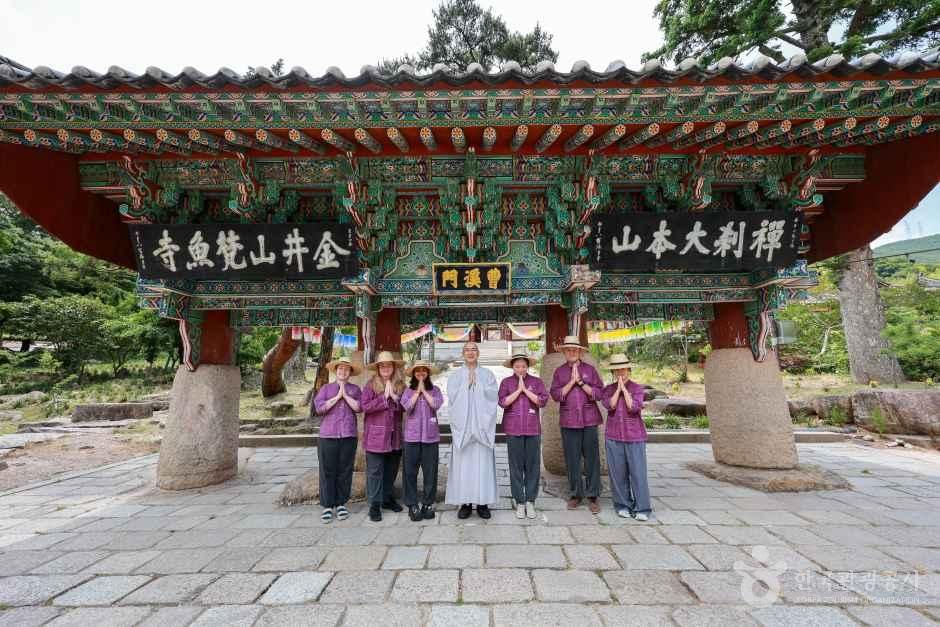 Participants smiling brightly at the Iljumun Gate (One Pillar Gate) of Beomeosa Temple