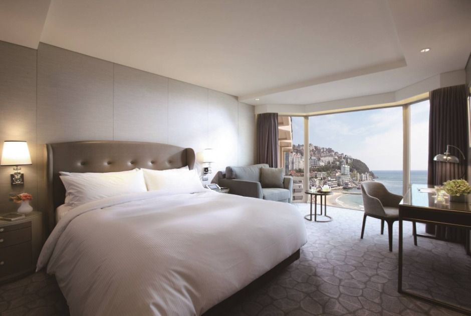Deluxe Ocean king room at Paradise Hotel Busan with a corner window and a side view of Haeundae Beach