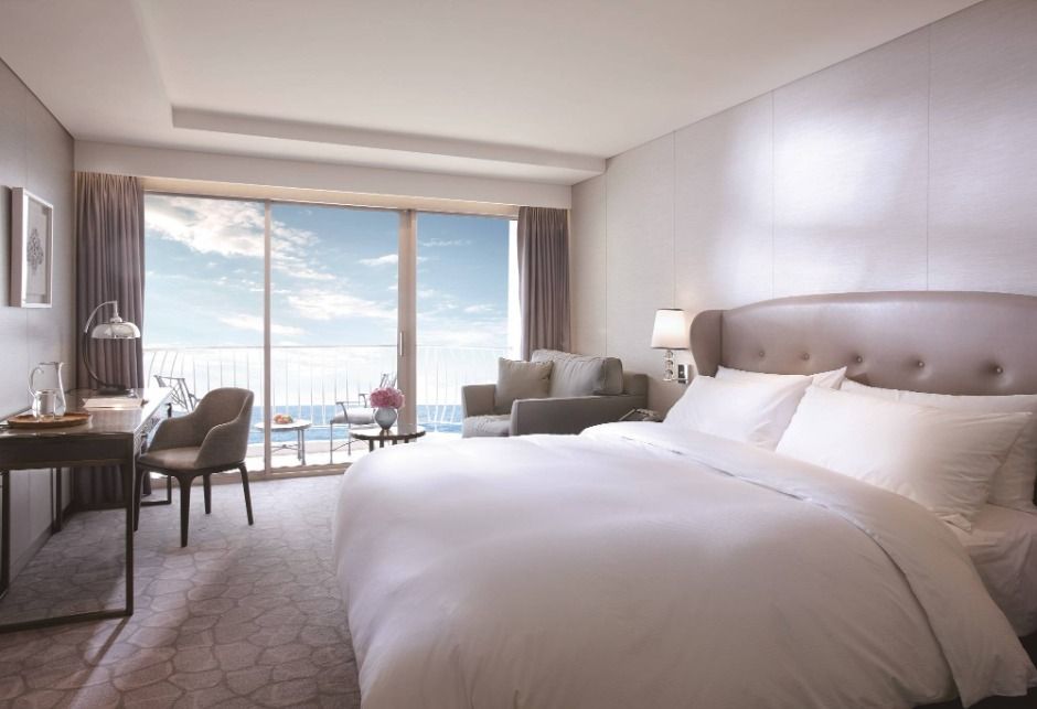 Deluxe Ocean Terrace room at Paradise Hotel Busan with a private balcony facing the sea