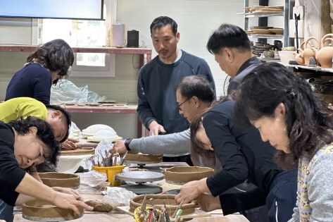 Visitors participating in the hand-building experience