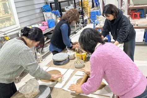 Visitors participating in the hand-building experience