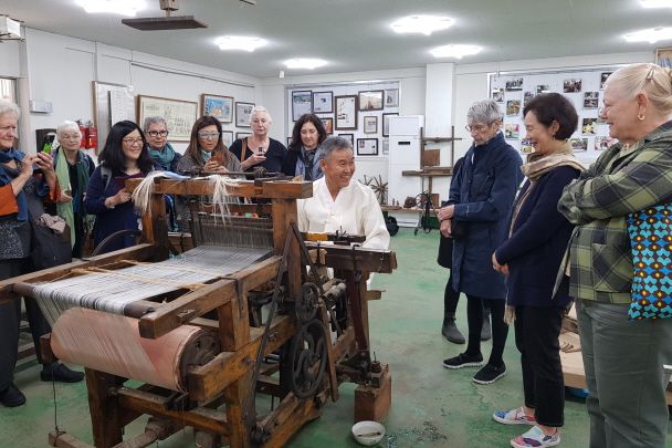 Visitors watching Heo’s demonstration before the weaving experience