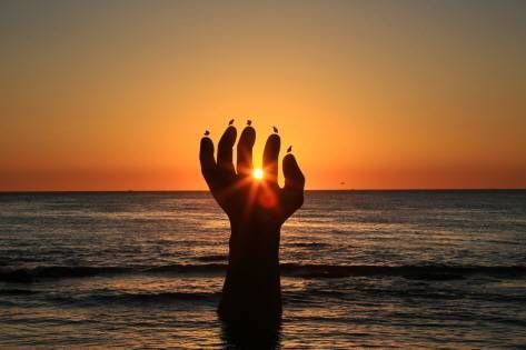 Sunrise seen beyond one of the Hands of Harmony (Credit: Clipart Korea)