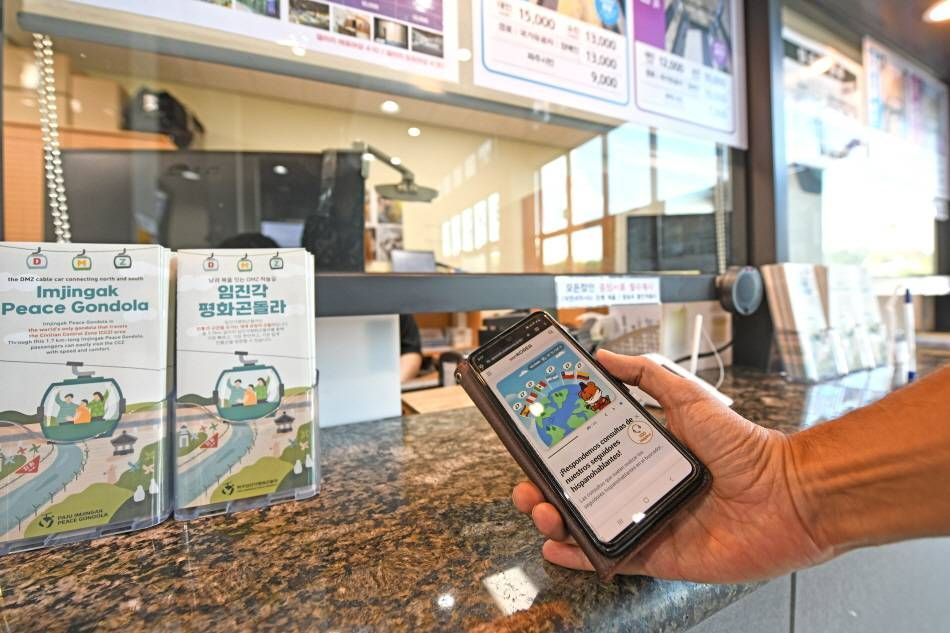 Showing the VISITKOREA app at the Imjingak Peace Gondola ticket booth