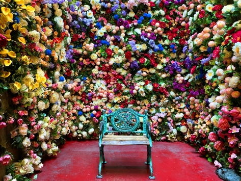 Chair surrounded by colorful flowers