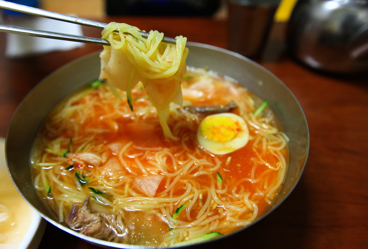 A bowl of milmyeon, Busan's wheat-flour cold noodles, with egg and cucumber